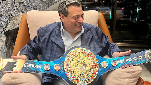 Mauricio Sulaiman – president of the WBC - with a commemorative belt for the Beterbiev-Bivol winner