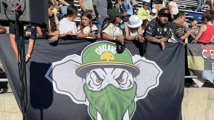 The Oakland Roots' supporter section, featuring an A's-themed logo.