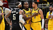 Indiana Pacers guard Tyrese Haliburton is restrained by forward Aaron Nesmith as Milwaukee Bucks guard Gary Trent Jr.