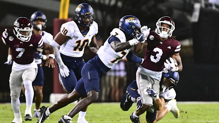 Sep 14, 2024; Starkville, Mississippi, USA; Mississippi State Bulldogs wide receiver Kevin Coleman Jr. (3) is tackled by Toledo Rockets safety Emmanuel McNeil-Warren (7) and Toledo Rockets safety Maxen Hook (25) during the second quarter at Davis Wade Stadium at Scott Field. Mandatory Credit: Matt Bush-Imagn Images