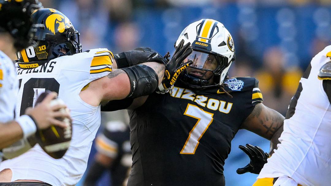 Dec 30, 2024; Nashville, TN, USA;  Missouri Tigers defensive tackle Chris McClellan (7) rushes Iowa Hawkeyes quarterback Brendan Sullivan (1) during the first half at Nissan Stadium. Mandatory Credit: Steve Roberts-Imagn Images