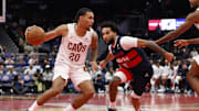 Nov 7, 2025; Washington, District of Columbia, USA; Cleveland Cavaliers guard Jaylon Tyson (20) drives to the basket as Washington Wizards forward Justin Champagnie (9) defends in the second half in an Emirates NBA Cup game at Capital One Arena. Mandatory Credit: Geoff Burke-Imagn Images