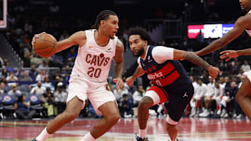 Nov 7, 2025; Washington, District of Columbia, USA; Cleveland Cavaliers guard Jaylon Tyson (20) drives to the basket as Washington Wizards forward Justin Champagnie (9) defends in the second half in an Emirates NBA Cup game at Capital One Arena. Mandatory Credit: Geoff Burke-Imagn Images