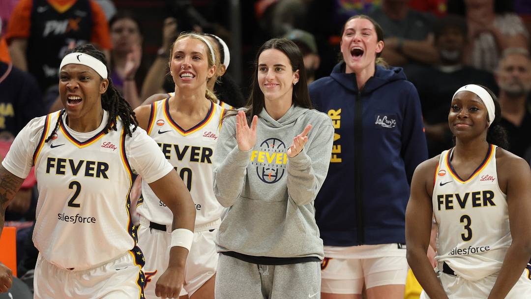 Indiana Fever guard Caitlin Clark (center) celebrates with her teammates.