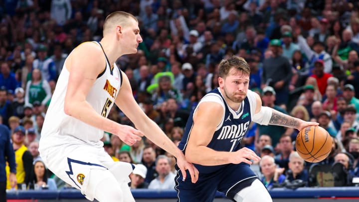 Mar 17, 2024; Dallas, Texas, USA;  Dallas Mavericks guard Luka Doncic (77) drives to the basket as Denver Nuggets center Nikola Jokic (15) during the second half at American Airlines Center. Mandatory Credit: Kevin Jairaj-USA TODAY Sports