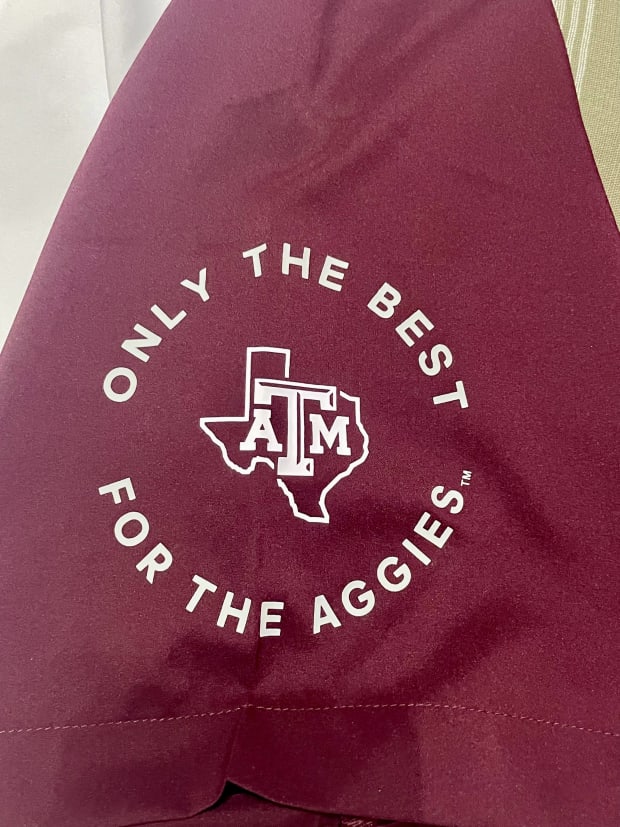 A sleeve of one of the Texas A&M Adidas-branded fan-apparel sweatshirts features a simple phrase re-used among other Adidas programs.