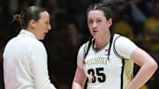 Purdue Boilermakers head coach Katie Gearlds talks to forward Lana McCarthy (35) 