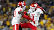 Oct 25, 2025; Tempe, Arizona, USA; Houston Cougars defensive back C.J. Douglas (13) and Kentrell Webb (8) celebrate a play against the Arizona State Sun Devils in the second half at Mountain America Stadium. Mandatory Credit: Mark J. Rebilas-Imagn Images