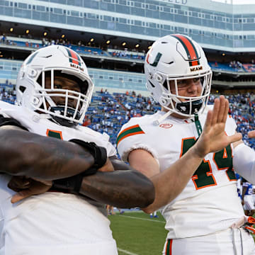 Aug 31, 2024; Gainesville, Florida, USA; Miami Hurricanes defensive lineman Armondo Blount (18) and Miami Hurricanes defensive lineman Cole McConathy II (44) celebrate against the Florida Gators after the game at Ben Hill Griffin Stadium. Mandatory Credit: Matt Pendleton-USA TODAY Sports