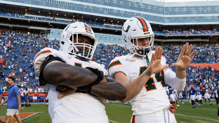 Aug 31, 2024; Gainesville, Florida, USA; Miami Hurricanes defensive lineman Armondo Blount (18) and Miami Hurricanes defensive lineman Cole McConathy II (44) celebrate against the Florida Gators after the game at Ben Hill Griffin Stadium. Mandatory Credit: Matt Pendleton-USA TODAY Sports