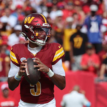 Sep 8, 2024; Tampa, Florida, USA;  Washington Commanders quarterback Jayden Daniels (5) drop back against the Tampa Bay Buccaneers during the first quarter at Raymond James Stadium. Mandatory Credit: Kim Klement Neitzel-Imagn Images