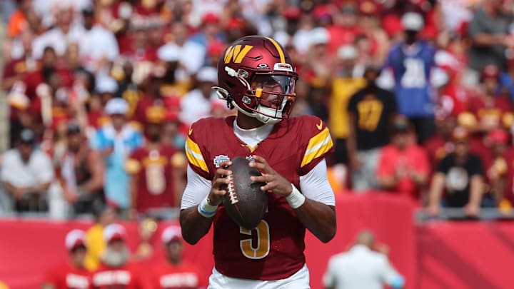 Sep 8, 2024; Tampa, Florida, USA;  Washington Commanders quarterback Jayden Daniels (5) drop back against the Tampa Bay Buccaneers during the first quarter at Raymond James Stadium. Mandatory Credit: Kim Klement Neitzel-Imagn Images