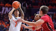Nov 8, 2024; Champaign, Illinois, USA;  Illinois Fighting Illini forward Will Riley (7) shoots the ball over SIU Edwardsville Cougars forward Jo Valrie (33) during the first half at State Farm Center. Mandatory Credit: Ron Johnson-Imagn Images