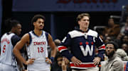 Dec 8, 2024; Washington, District of Columbia, USA; Washington Wizards guard Jordan Poole (13) and injured Wizards forward Corey Kispert (R) look on from the bench against the Memphis Grizzlies in the third quarter at Capital One Arena. Mandatory Credit: Geoff Burke-Imagn Images