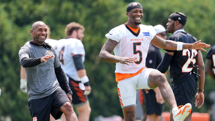 Jul 26, 2024; Cincinnati, OH, USA; Cincinnati Bengals wide receiver Tee Higgins (middle) smiles as he stretches during training camp practice at Kettering Health Practice Fields. Mandatory Credit: Kareem Elgazzar-USA TODAY Sports