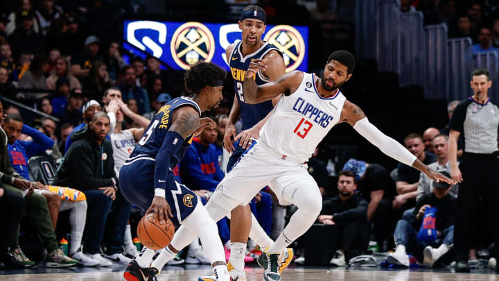 Jan 5, 2023; Denver, Colorado, USA; Los Angeles Clippers guard Paul George (13) gets tripped up with forward Zeke Nnaji (22) as he guards guard Kentavious Caldwell-Pope (5) in the second quarter at Ball Arena. Mandatory Credit: Isaiah J. Downing-USA TODAY Sports