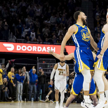 Jan 4, 2024; San Francisco, California, USA; Golden State Warriors guard Brandin Podziemski (2) celebrates with guard Stephen Curry (30)  against the Denver Nuggets at Chase Center.