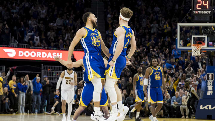 Jan 4, 2024; San Francisco, California, USA; Golden State Warriors guard Brandin Podziemski (2) celebrates with guard Stephen Curry (30)  against the Denver Nuggets at Chase Center.