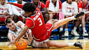 Michigan State center Carson Cooper (15) and New Mexico guard Tru Washington (3) battle for the loose ball during the first half of the Second Round of NCAA tournament at Rocket Arena in Cleveland, Ohio on Sunday, March 23, 2025.