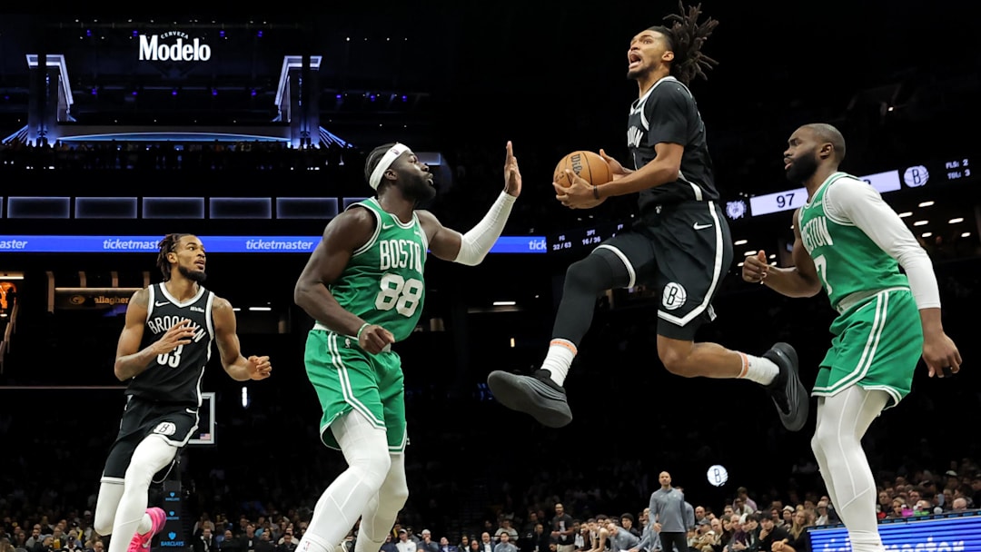 Nov 18, 2025; Brooklyn, New York, USA; Brooklyn Nets forward Ziaire Williams (1) drives to the basket against Boston Celtics center Neemias Queta (88) and guard Jaylen Brown (7) during the fourth quarter at Barclays Center. Mandatory Credit: Brad Penner-Imagn Images