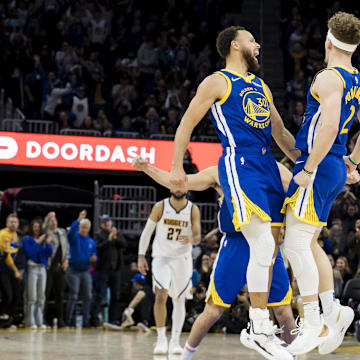 Golden State Warriors guard Brandin Podziemski (2) celebrates with forward Klay Thompson (11) and guard Stephen Curry (30) after he scored against the Denver Nuggets during the second half at Chase Center. Mandatory Credit: John Hefti-Imagn Images