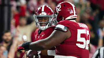 Nov 4, 2023; Tuscaloosa, Alabama, USA; Alabama Crimson Tide quarterback Jalen Milroe (4) celebrates his touchdown against the LSU Tigers with offensive lineman Tyler Booker (52) during the second half at Bryant-Denny Stadium. Alabama Crimson Tide defeated the LSU Tigers 42-28. Mandatory Credit: John David Mercer-Imagn Images