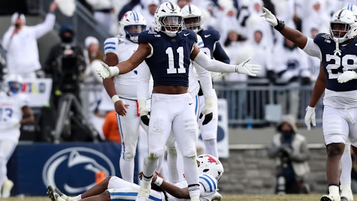 Dec 21, 2024; University Park, Pennsylvania, USA; Penn State Nittany Lions defensive end Abdul Carter (11) reacts after sacking Southern Methodist Mustangs quarterback Kevin Jennings (7) during the third quarter in the first round of the College Football Playoff at Beaver Stadium. Mandatory Credit: Matthew O'Haren-Imagn Images