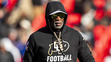 Nov 23, 2024; Kansas City, Missouri, USA;  Colorado head coach Deion Sanders watches his players warmup prior to the game between the Kansas Jayhawks and the Colorado Buffaloes at GEHA Field at Arrowhead Stadium. 