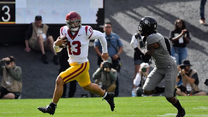 Sep 30, 2023; Boulder, Colorado, USA; USC Trojans quarterback Caleb Williams (13) scrambles for a few yards as he gets chased by Colorado Buffaloes safety Jahquez Robinson (8) during the first quarter at Folsom Field. Mandatory Credit: John Leyba-USA TODAY Sports
