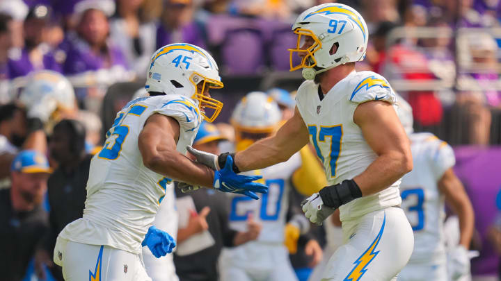 Sep 24, 2023; Minneapolis, Minnesota, USA; Los Angeles Chargers linebacker Joey Bosa (97) and linebacker Tuli Tuipulotu (45) celebrate his sack against the Minnesota Vikings in the first quarter at U.S. Bank Stadium. Mandatory Credit: Brad Rempel-USA TODAY Sports