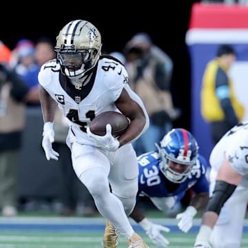 Dec 8, 2024; East Rutherford, New Jersey, USA; New Orleans Saints running back Alvin Kamara (41) runs with the ball against the New York Giants during the second quarter at MetLife Stadium. Mandatory Credit: Brad Penner-Imagn Images