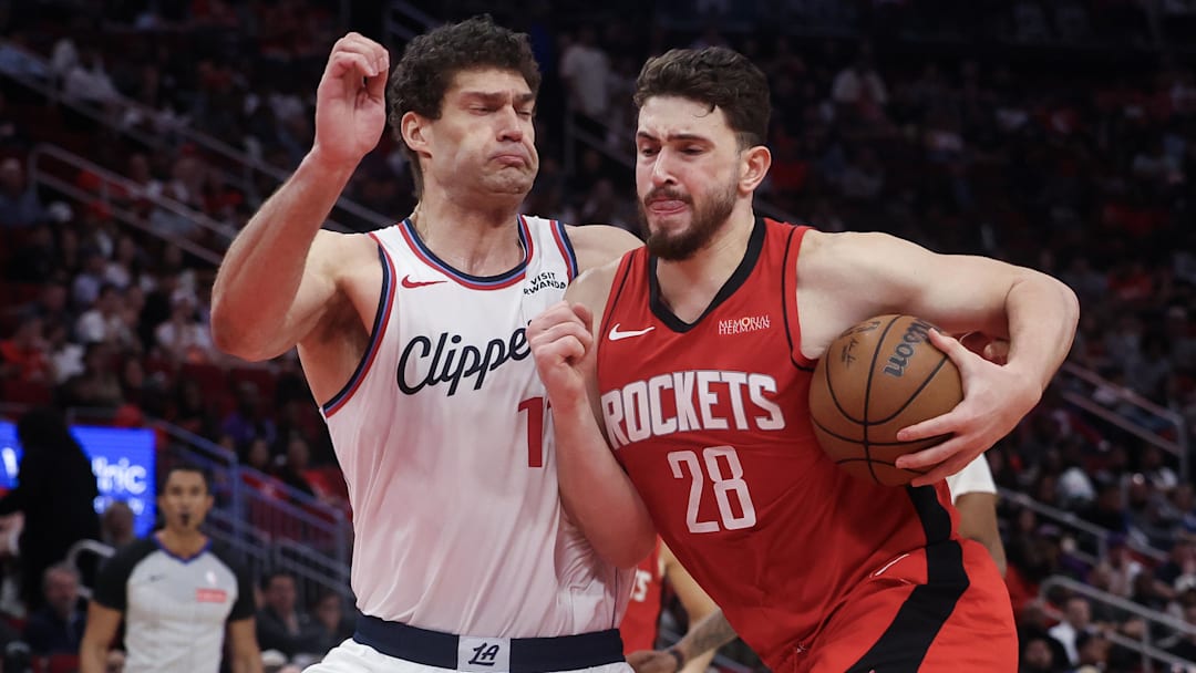 Feb 11, 2026; Houston, Texas, USA; Houston Rockets center Alperen Sengun (28) drives to the net against Los Angeles Clippers center Brook Lopez (11) in the second half at Toyota Center. Mandatory Credit: Thomas Shea-Imagn Images