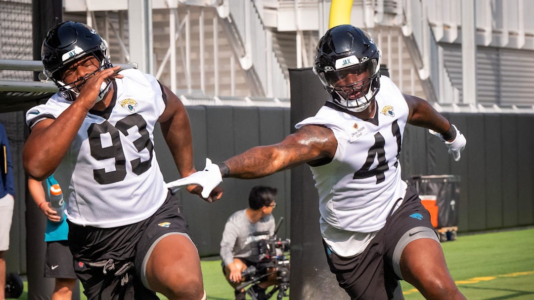 Jacksonville Jaguars defensive tackle Tyler Lacy (93) and Jacksonville Jaguars defensive end Josh Hines-Allen (41) run through drills during the seventh organized team activity at the Miller Electric Center in Jacksonville, Fla. Monday, June 2, 2025. 