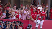 Oct 4, 2025; Lincoln, Nebraska, USA; Nebraska Cornhusker fans celebrate with running back Emmett Johnson (21) after a touchdown during the game against Michigan State at Memorial Stadium. Mandatory Credit: Kylie Graham-Imagn Images
