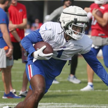 Bills wide receiver Curtis Samuel puts out the stiff arm.