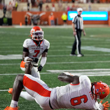 Texas Longhorns quarterback Arch Manning (16) runs in for a touchdown past Sam Houston Bearkats linebacker Antivirus Fish (6) during the first half at Darrell K Royal-Texas Memorial Stadium.