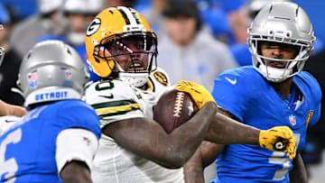 Nov 27, 2025; Detroit, Michigan, USA; Green Bay Packers running back Josh Jacobs (8) runs the ball against Detroit Lions cornerback Terrion Arnold (6) during the second quarter at Ford Field.