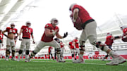 The Wisconsin Badgers offensive line runs drills during spring football practice at Camp Randall Stadium in Madison