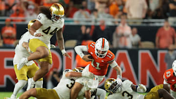 Aug 31, 2025; Miami Gardens, Florida, USA; Miami Hurricanes quarterback Carson Beck (11) rushes the ball against the Notre Dame Fighting Irish during the second quarter at Hard Rock Stadium. Mandatory Credit: Sam Navarro-Imagn Images