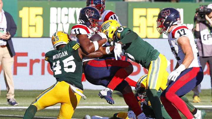 Jun 14, 2024; Edmonton, Alberta, CAN; Montreal Alouettes wide receiver Kaion Julien-Grant (11) is tackled by Edmonton Elks linebacker Nyles Morgan (45) during the first half at Commonwealth Stadium. Mandatory Credit: Perry Nelson-USA TODAY Sports