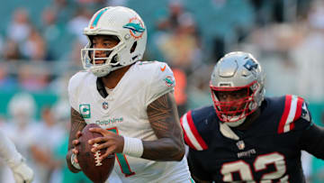 Nov 24, 2024; Miami Gardens, Florida, USA; Miami Dolphins quarterback Tua Tagovailoa (1) runs with the football against the New England Patriots during the fourth quarter at Hard Rock Stadium. Mandatory Credit: Sam Navarro-Imagn Images
