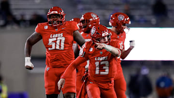 Nov 22, 2025; Colorado Springs, Colorado, USA; New Mexico Lobos quarterback James Laubstein (13) and offensive lineman Isaiah Sillemon (50).
