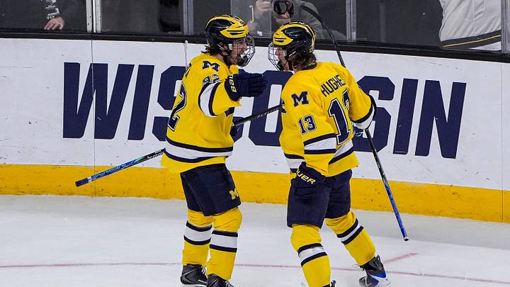 Michigan forward T.J. Hughes (13) celebrates scoring a goal against Denver with forward Adam Valentini (92) during the first period of the Frozen Four semifinal at T-Mobile Arena in Las Vegas on Thursday, April 9, 2026
