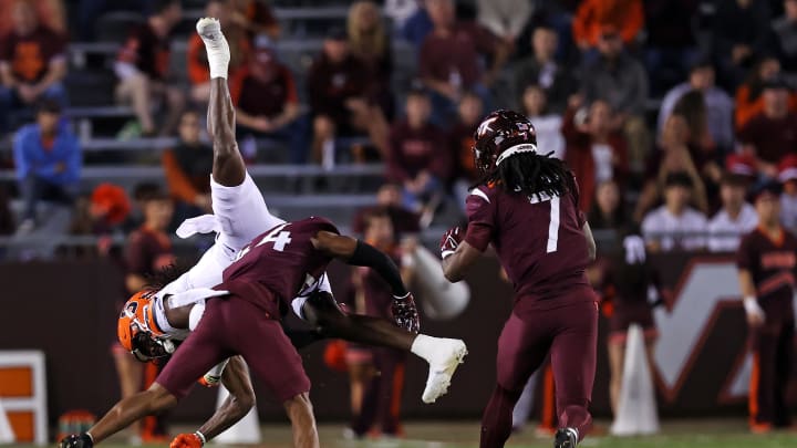 Oct 26, 2023; Blacksburg, Virginia, USA; Syracuse Orange wide receiver Damien Alford (5) is tackled by Virginia Tech Hokies cornerback Dorian Strong (44) during the third quarter at Lane Stadium. Mandatory Credit: Peter Casey-USA TODAY Sports