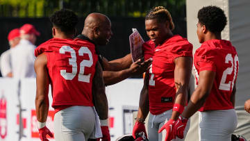 Aug 1, 2024; Columbus, OH, USA; Ohio State Buckeyes running backs coach Carlos Locklyn works with running backs TreVeyon Henderson (32), Quinshon Judkins (1) and James Peoples (20) during football camp at the Woody Hayes Athletic Complex.