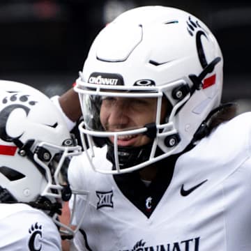 Cincinnati Bearcats quarterback Brendan Sorsby (2) reacts with Cincinnati Bearcats wide receiver Tyrin Smith (4) after scoring a touchdown in the first quarter of the College Football game between the Cincinnati Bearcats and the Towson Tigers at Nippert Stadium in Cincinnati on Saturday, Aug. 31, 2024.