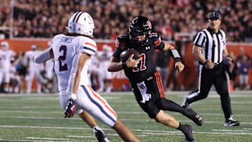 Sep 28, 2024; Salt Lake City, Utah, USA; Utah Utes quarterback Isaac Wilson (11) runs against Arizona Wildcats defensive back Treydan Stukes (2) during the second quarter at Rice-Eccles Stadium. Mandatory Credit: Rob Gray-Imagn Images