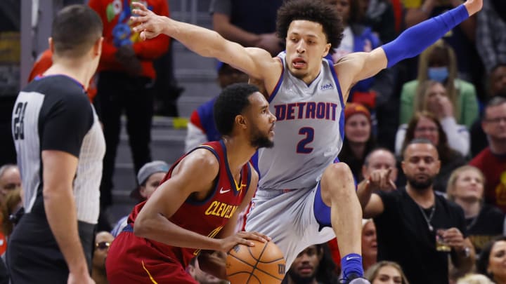 Feb 24, 2022; Detroit, Michigan, USA;  Cleveland Cavaliers center Evan Mobley (4) is defended by Detroit Pistons guard Cade Cunningham (2) in the second half at Little Caesars Arena. Mandatory Credit: Rick Osentoski-USA TODAY Sports