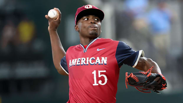 American League Future  pitcher Emiliano Teodo throws in an all-star game wearing a red jersey and hat