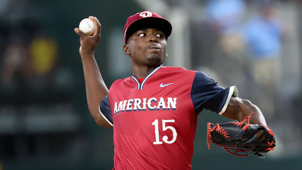 American League Future  pitcher Emiliano Teodo (15) throws the ball in a red uniform